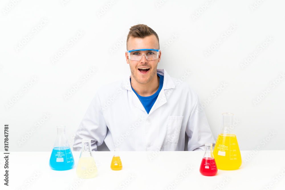 Young scientific with lots of laboratory flask with surprise facial expression Young scientific with lots of laboratory flask with surprise facial expression