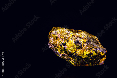 Photo uranium mineral isolated on black background