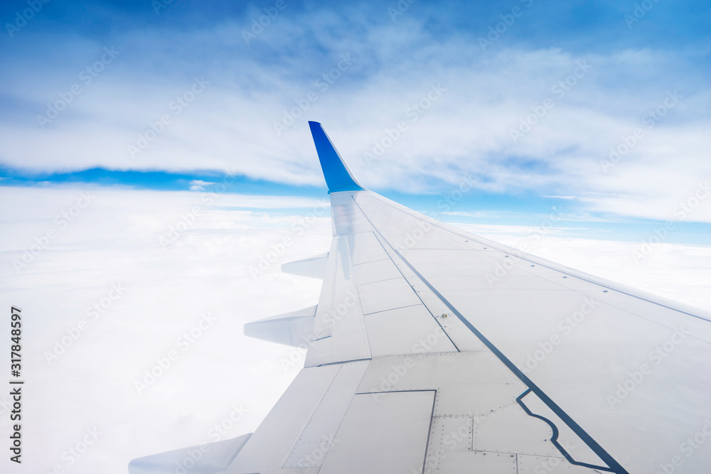 Clouds and sky as seen through window of an aircraft