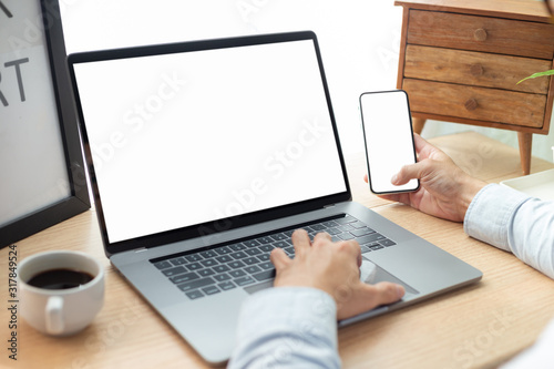 mockup image blank screen computer,cell phone with white background for advertising text,hand man using laptop texting mobile contact business search information on desk in cafe.marketing,design