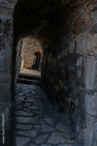 View through an arched passage in a thick rampart