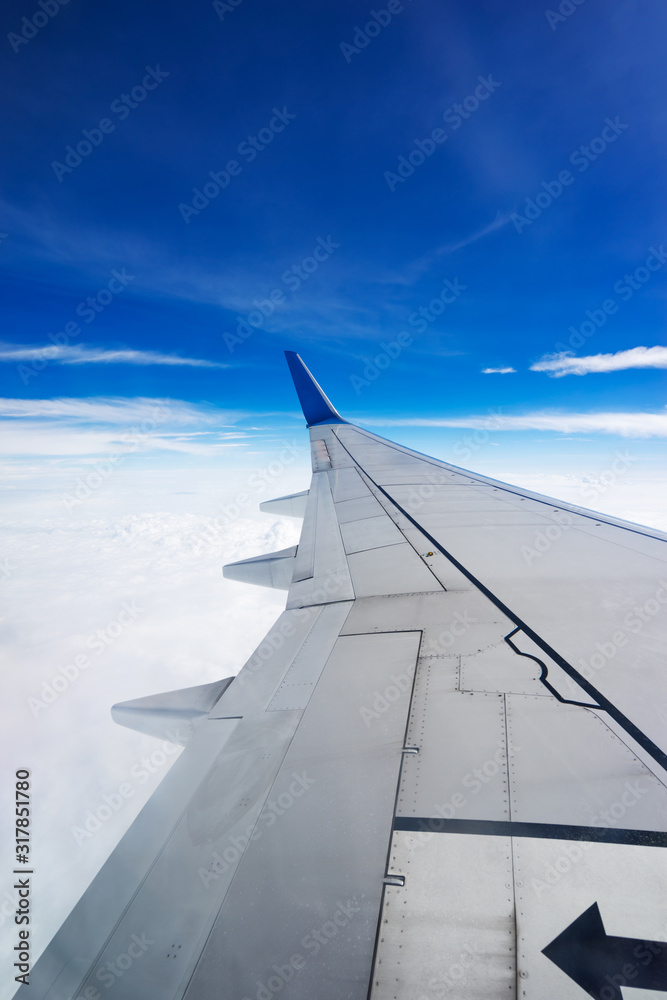 Clouds and sky as seen through window of an aircraft Clouds and sky as seen through window of an aircraft