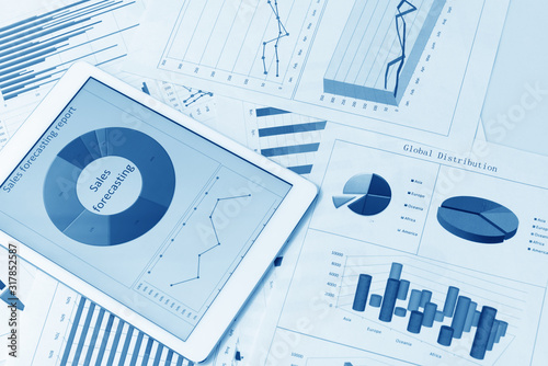 Financial charts on the table with tablet