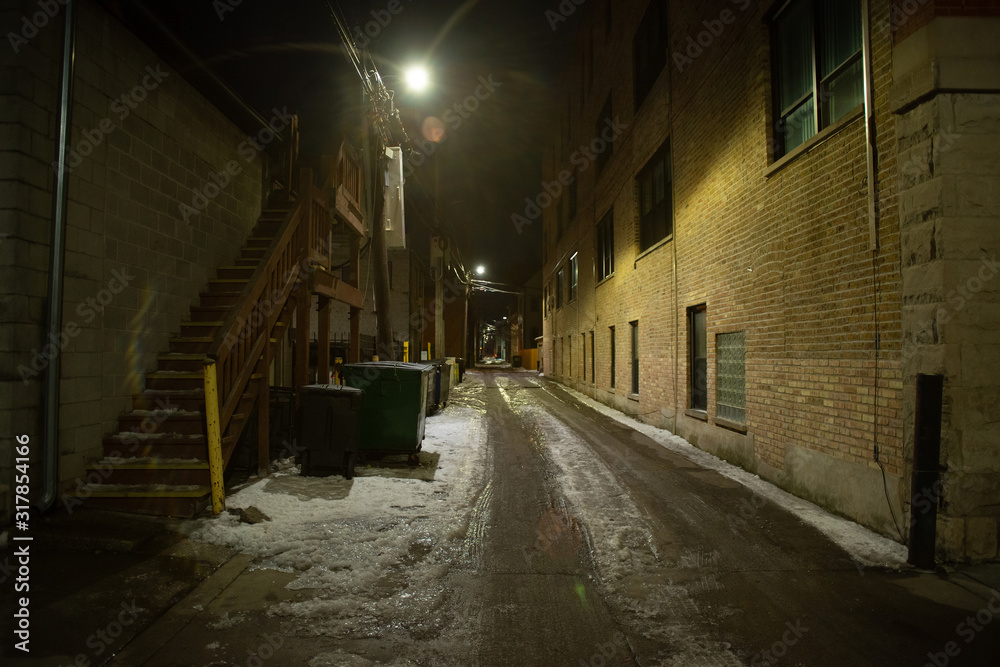 Dark and eerie urban city alley at night 