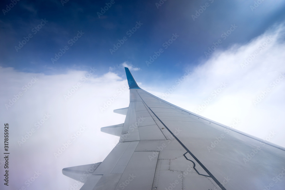 Fototapeta premium Clouds and sky as seen through window of an aircraft