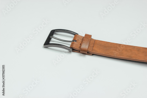 Leather brown belt on a white background