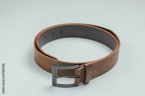 Leather brown belt on a white background