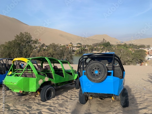 colorful sand buggies near oasis