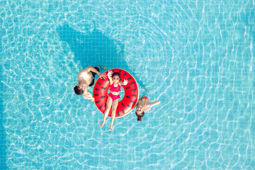 Asian family relax in swimming pool