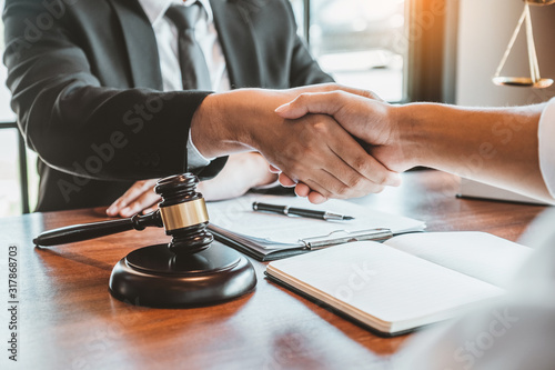 Businessman shaking hands to seal a deal Judges male lawyers Consultation legal services Consulting in regard to the various contracts to plan the case in court. photo