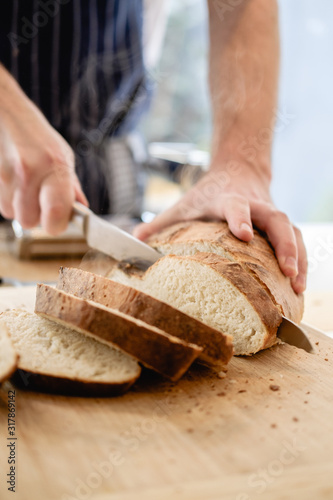 Chef cutting fresh home made bread