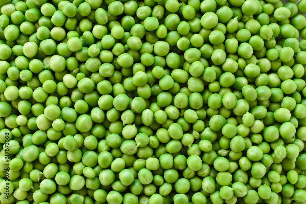 Green peas, peeled of tricks. Background. Vegetarianism.