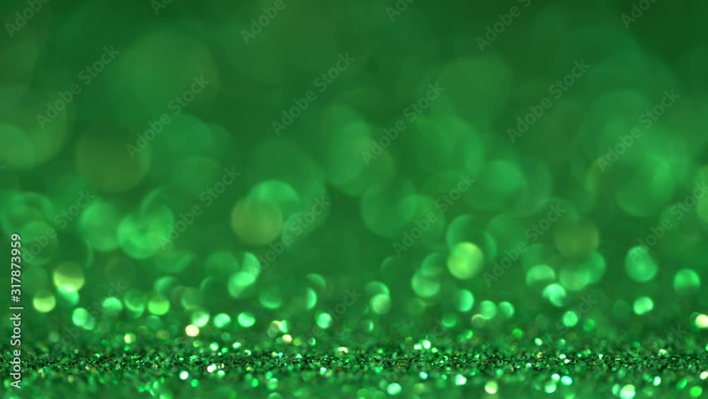 Green brilliant beautiful holiday texture in motion. Magic bokeh background Green brilliant beautiful holiday texture in motion. Magic bokeh background