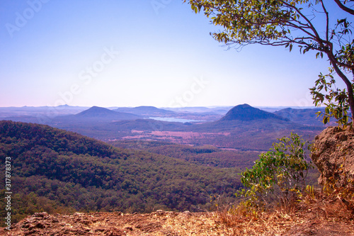 Scenic view from Mount Cordeaux Lookout with a tree and an edge of cliff on a foredround. Main Range National Park, Queensland, Ausralia