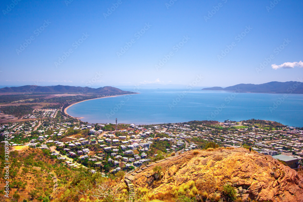 Scenic view from the Castle Hill Lookout at Townsville (Queensland, Australia) to the town, coast line and Magnetic Island. S-shape line of coast.