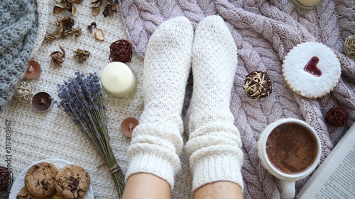 Top View Of Woman Feet In Cozy Knitted Socks. Winter Holiday Concept.