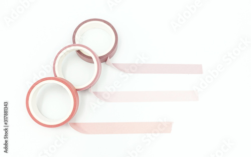 Fotografie Close up top view of paper masking tape in set of pink arranging in a row and taping on board