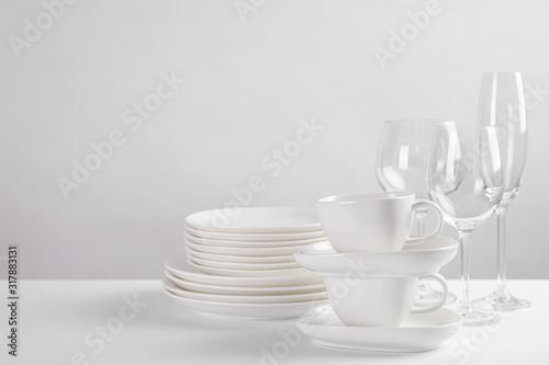 Set of clean dishes on white table