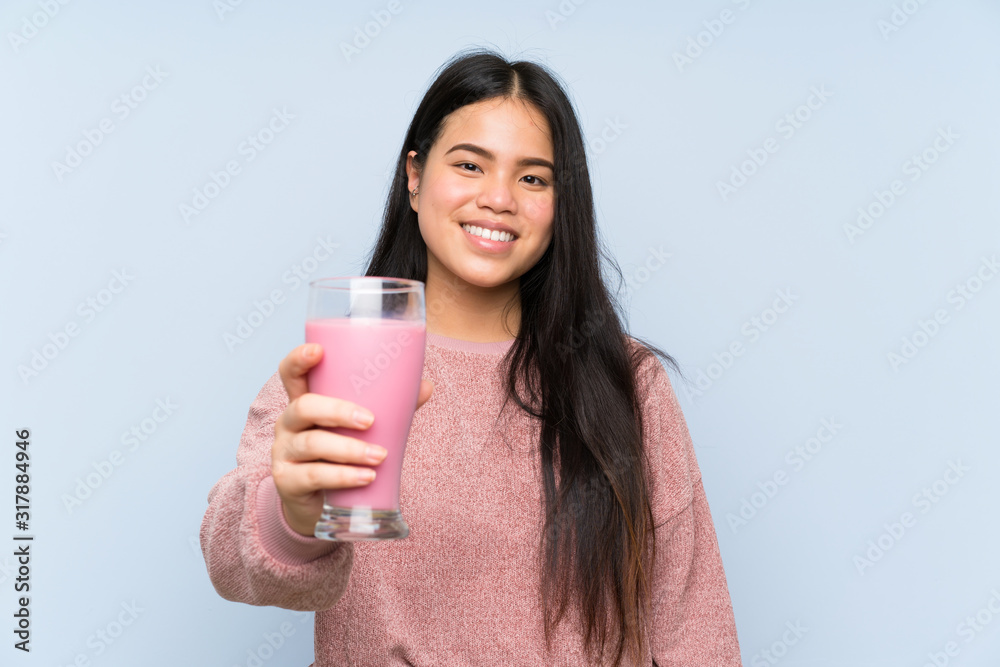 Young teenager Asian girl with strawberry milkshake Young teenager Asian girl with strawberry milkshake