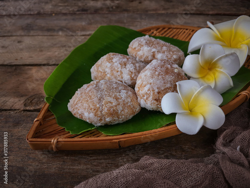 A Malay traditional dessert called Gagatas or Getas on bamboo dustpan over wooden background. photo