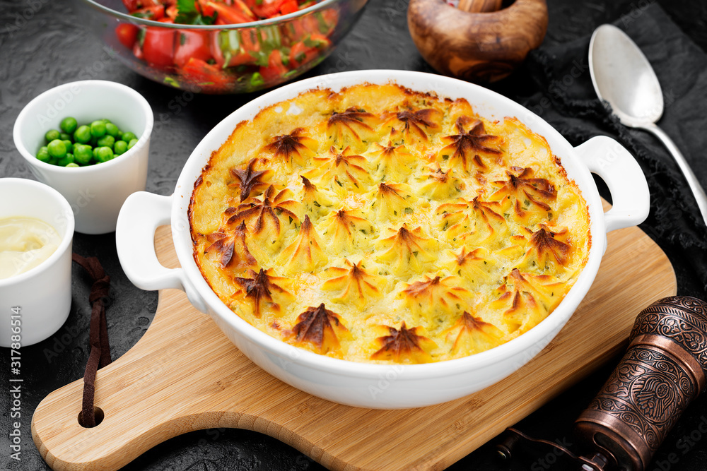 Fish pie with salmon, mashed potatoes, green peas and creamy sauce. Fish pie with salmon, mashed potatoes, green peas and creamy sauce.