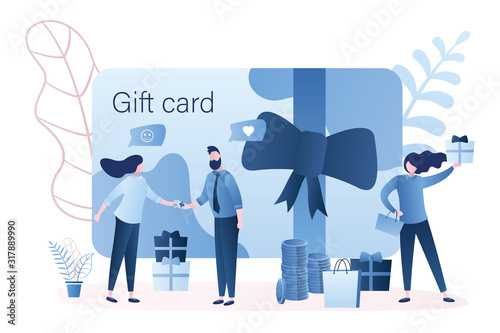 Gift card and promotion strategy.Handsome man gives woman plastic gift voucher.