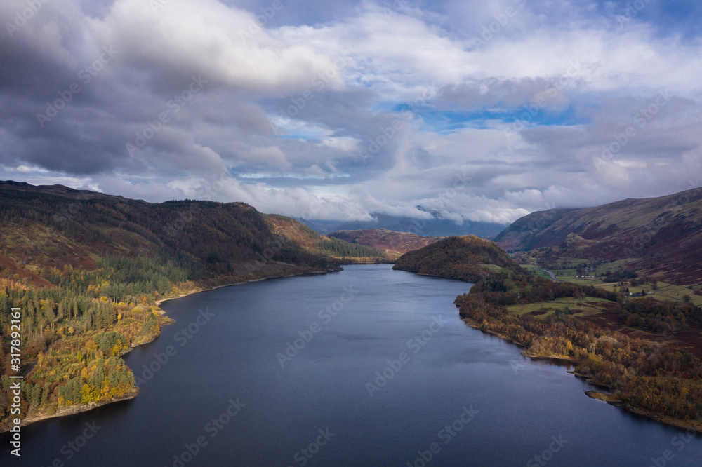 Stunning aerial drone landscape image of glorious vibrant Autumn Fall sun over Thirlmere in Lake District