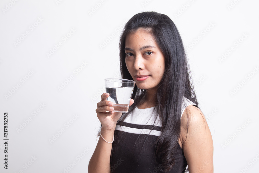 Young Asian woman with a glass of drinking water. Young Asian woman with a glass of drinking water.