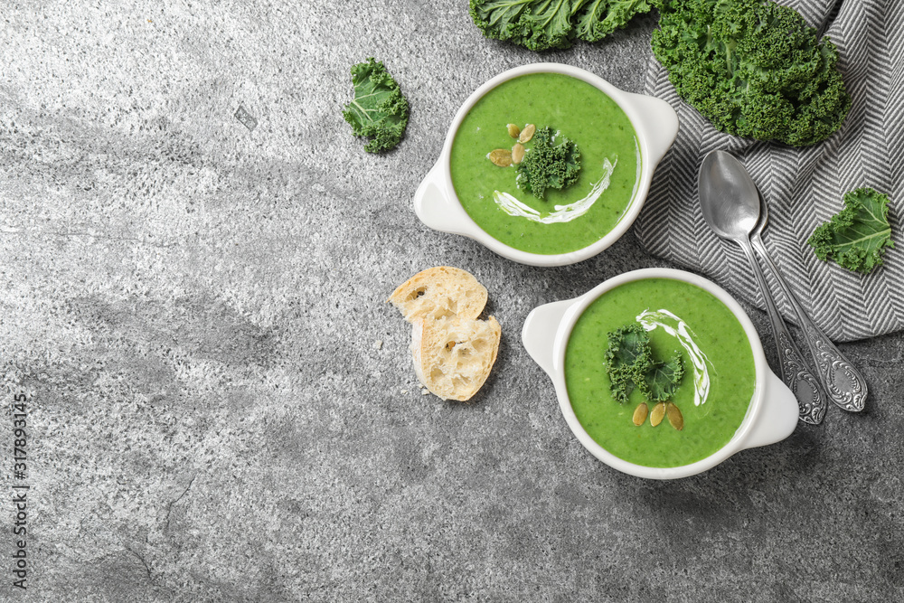 Tasty kale soup served on grey table, flat lay. Space for text Tasty kale soup served on grey table, flat lay. Space for text