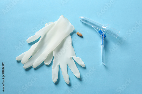 Wallpaper Mural Anoscope, suppository and rubber gloves on light blue background, flat lay. Hemorrhoid treatment Torontodigital.ca