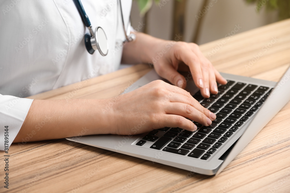 Doctor working with laptop at desk in office, closeup. Medical service Doctor working with laptop at desk in office, closeup. Medical service