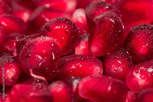 fresh pomegranate seeds macro close up in drops