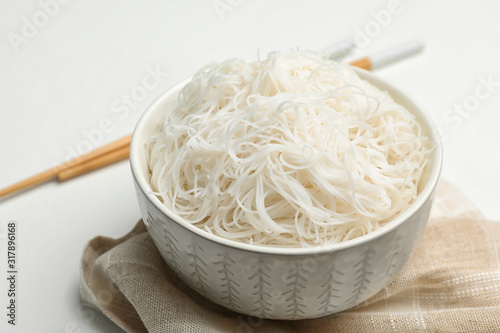 Tasty cooked rice noodles on white table, closeup photo