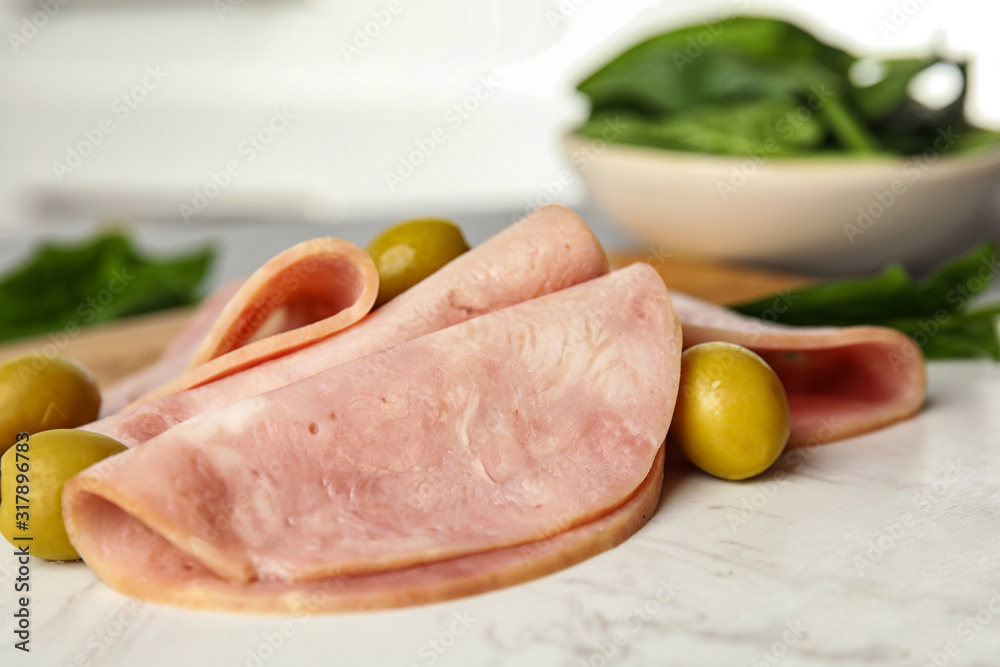 Ham with olives and spinach on table, closeup Ham with olives and spinach on table, closeup