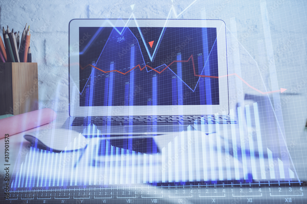 Financial chart drawing and table with computer on background. Double exposure. Concept of international markets. Financial chart drawing and table with computer on background. Double exposure. Concept of international markets.