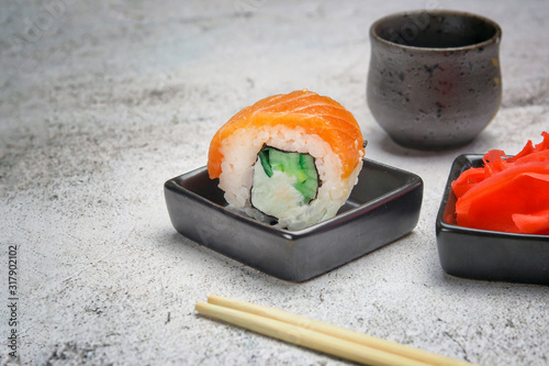 sushi roll on the table with seasoning and sake photo