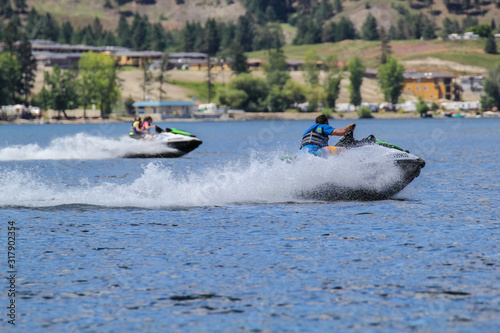 Canvas Print Two couple on speed boats jet ski having fun during water jet-ski jetski fast ri