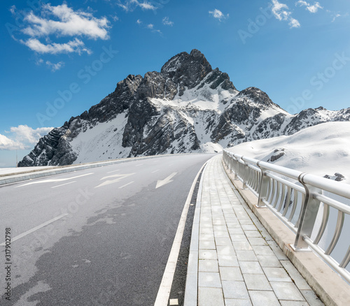 Snowy road under freezing blue sky