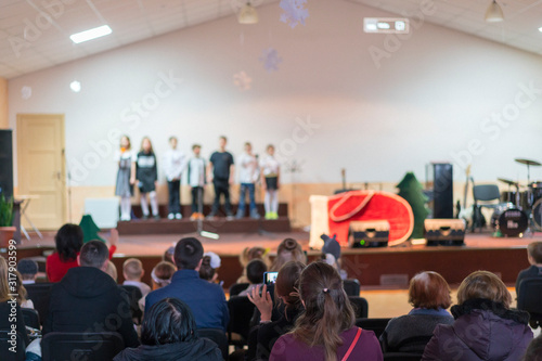 Wallpaper Mural Children at school perform on stage in front of parents. Young talents on stage. blurry Torontodigital.ca