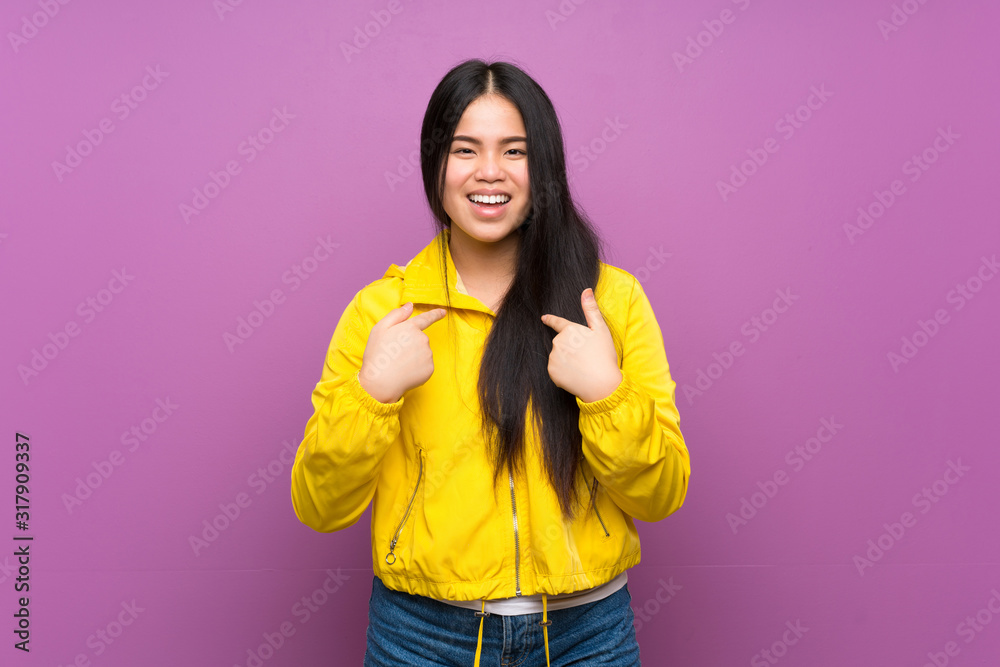 Young teenager Asian girl over isolated purple background with surprise facial expression Young teenager Asian girl over isolated purple background with surprise facial expression