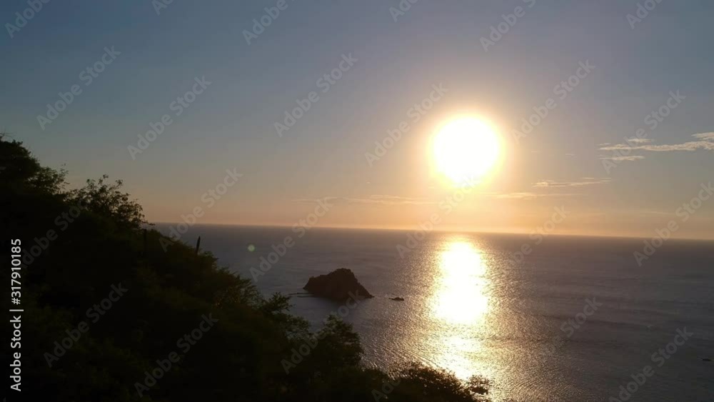 Aerial Ascending View From Silhouetted Trees Of Golden Yellow Sunset Above The Caribbean Ocean Aerial Ascending View From Silhouetted Trees Of Golden Yellow Sunset Above The Caribbean Ocean