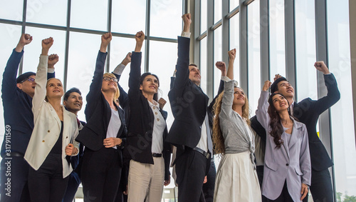 Group of team creative business people training together and Raise hands shows power in hall.Business seminar concept
