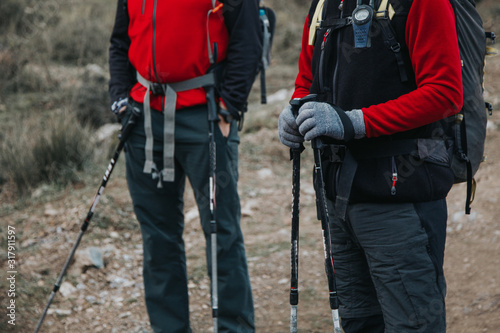 Close up of trekers hands with hiking equipmen in it. Traveling and hiking concept. 