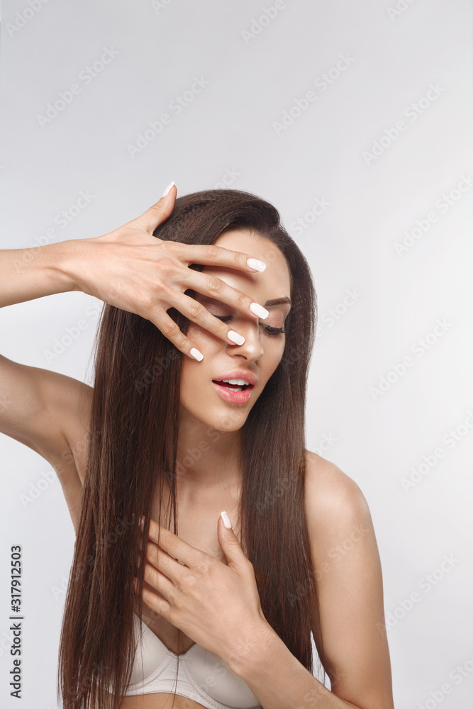 Fototapeta premium Beautiful woman with a French manicure nail , skin care concept, beautiful skin. Portrait of female hands with manicure nails. Сare for hands and nails and cosmetics