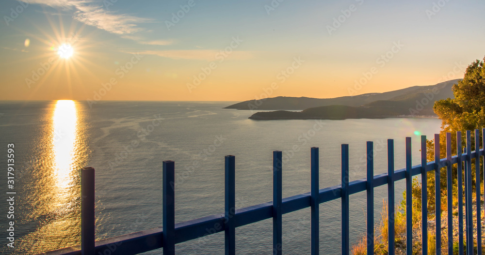 Golden sunrise sunset over the Adratic sea in Montenegro, view from the top of the Mogren Fortress in Budva.Quiet place. Relaxing scene.Calm sea water. Beautiful colors in the sky.