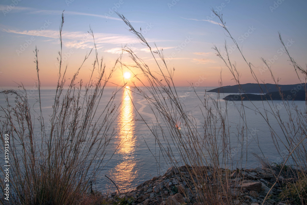 Golden sunrise sunset over the Adratic sea in Montenegro, view from the top of the Mogren Fortress in Budva.Quiet place. Relaxing scene.Calm sea water. Beautiful colors in the sky.