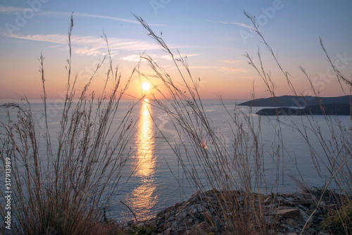 Obraz na płótnie Golden sunrise sunset over the Adratic sea in Montenegro, view from the top of the Mogren Fortress in Budva.Quiet place. Relaxing scene.Calm sea water. Beautiful colors in the sky. w salonie