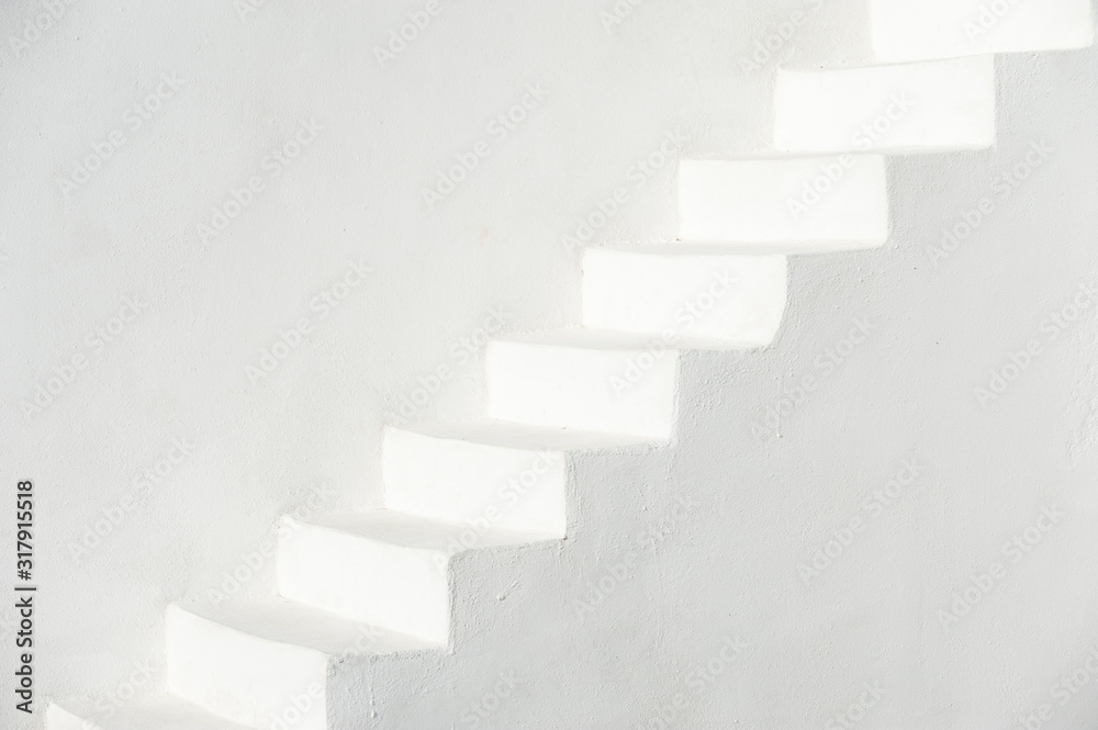 Traditional whitewashed Mediterranean staircase in Santorini, Greece with white stucco copy space Traditional whitewashed Mediterranean staircase in Santorini, Greece with white stucco copy space