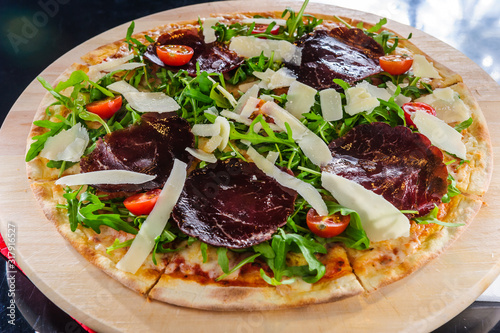 Pizza on table close up.Cut pizza.Italian traditional dish.