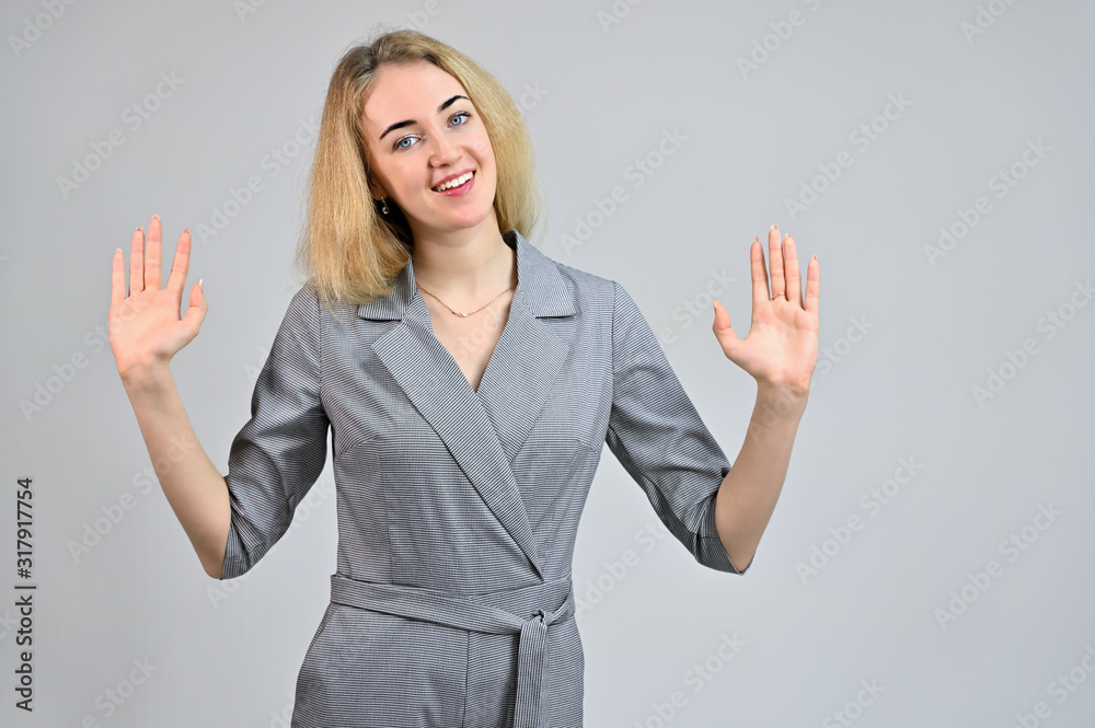 Model Standing directly in front of the camera in various poses. Portrait of a pretty cute smiling young blonde business woman with minimal makeup in a gray suit on a white background. Model Standing directly in front of the camera in various poses. Portrait of a pretty cute smiling young blonde business woman with minimal makeup in a gray suit on a white background.